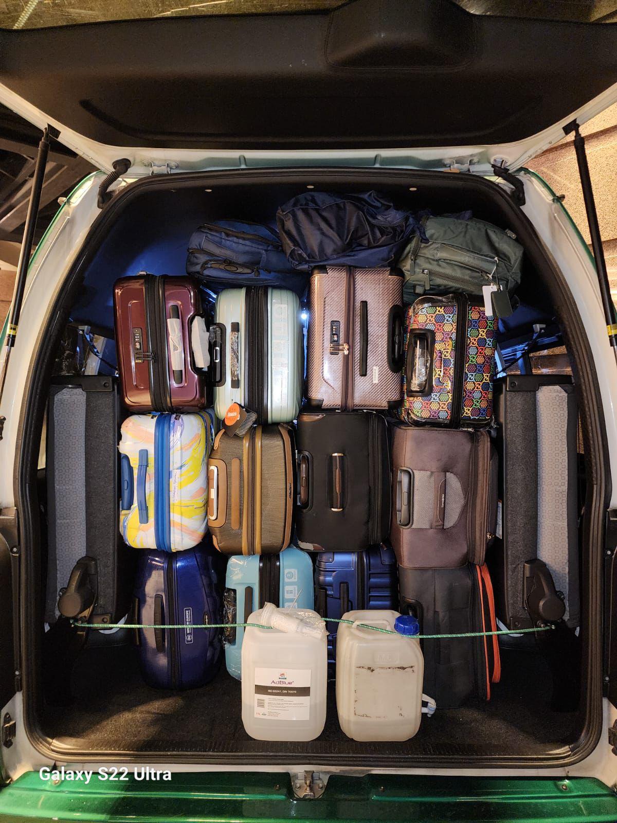 Rear luggage space fully loaded for airport transfer