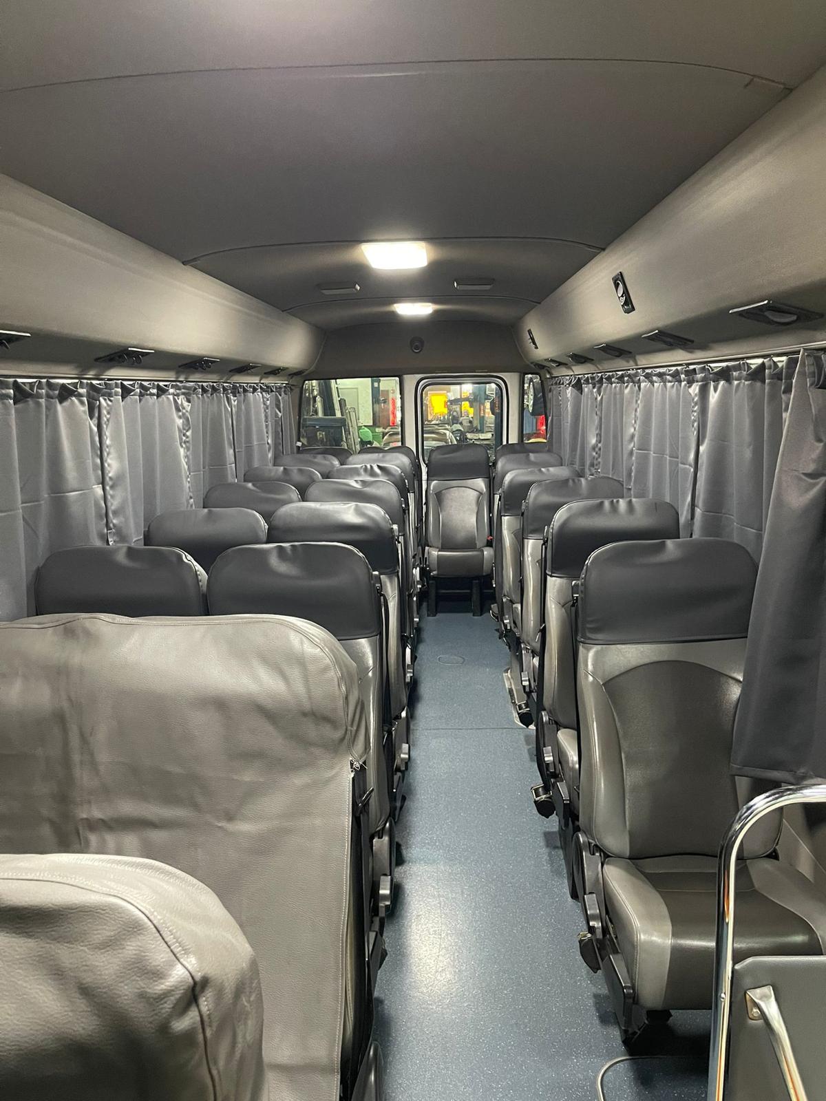 23-seater minibus interior with grey curtains