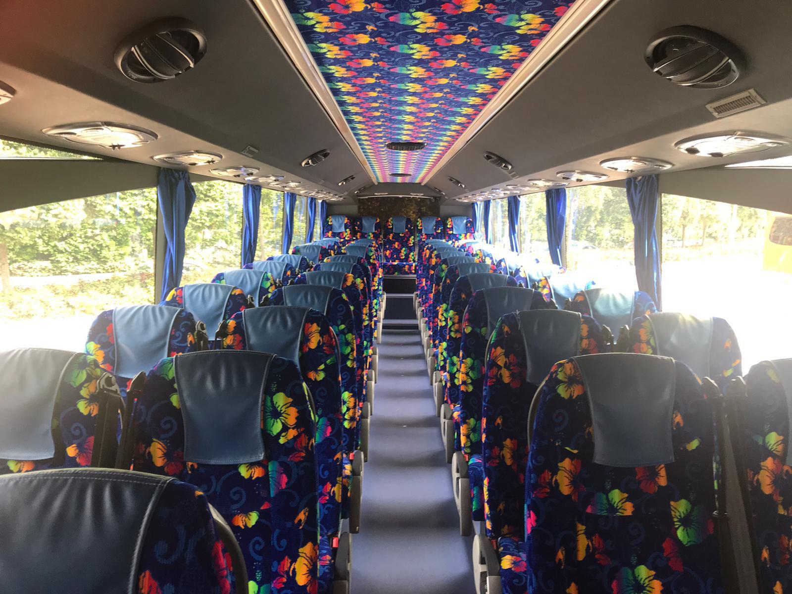Coach bus interior with vibrant floral patterned seats